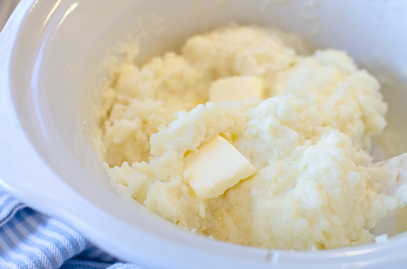 Slow Cooker Mashed Potatoes are creamy, buttery and delicious! Easy prep and little work gets the job done with these velvety rich mashed potatoes. No boiling required, just chop, mash and season for the best fluffy Slow Cooker Mashed Potatoes!