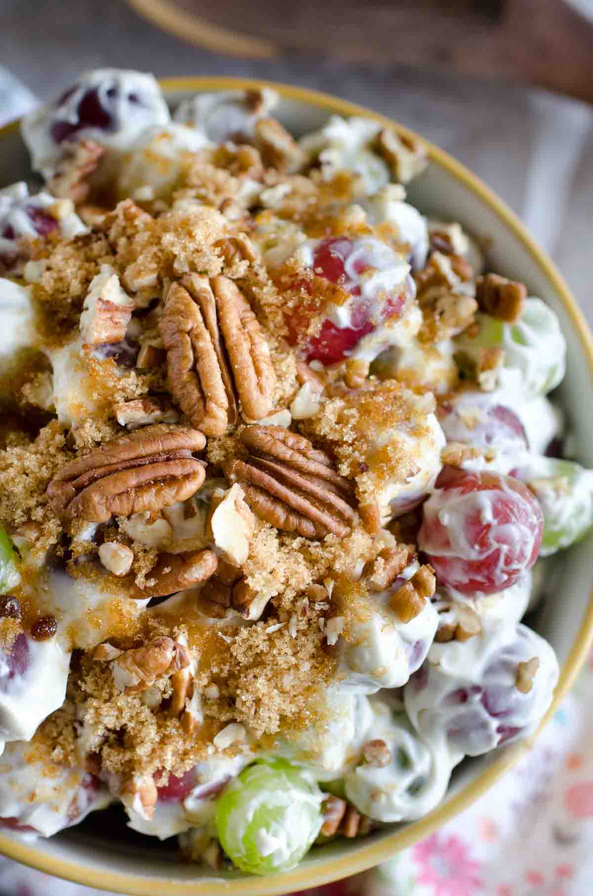 grape salad in a bowl topped with pecans