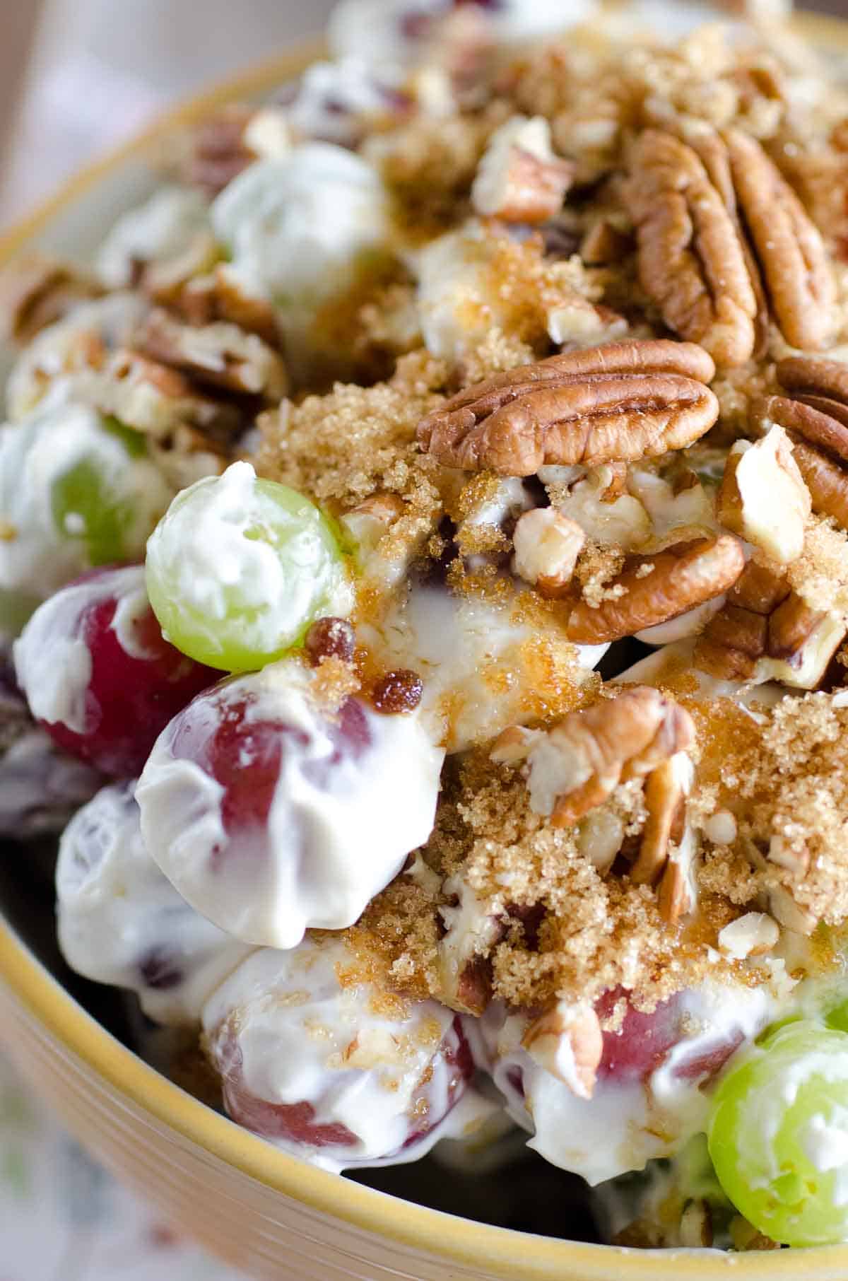 creamy grape salad in a bowl with pecans