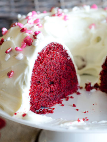 The best and easiest Red Velvet Bundt Cake made from scratch with a homemade cream cheese frosting. This red velvet cake is tender and moist with the perfect crumb to each slice!