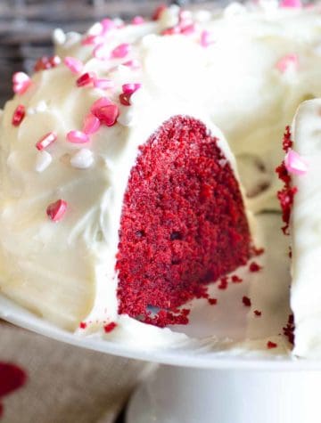 red velvet bundt cake with cream cheese frosting and pink sprinkles