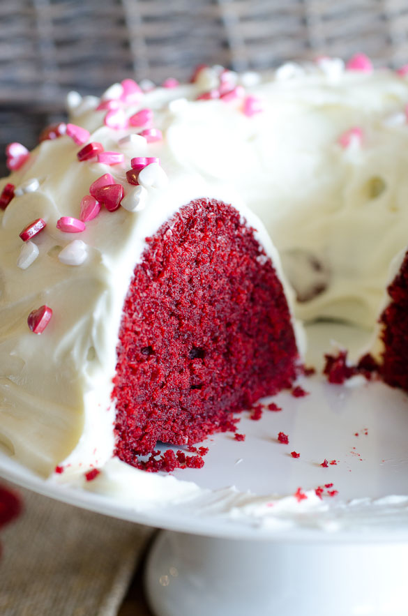The best and easiest Red Velvet Bundt Cake made from scratch with a homemade cream cheese frosting. This red velvet cake is tender and moist with the perfect crumb to each slice!