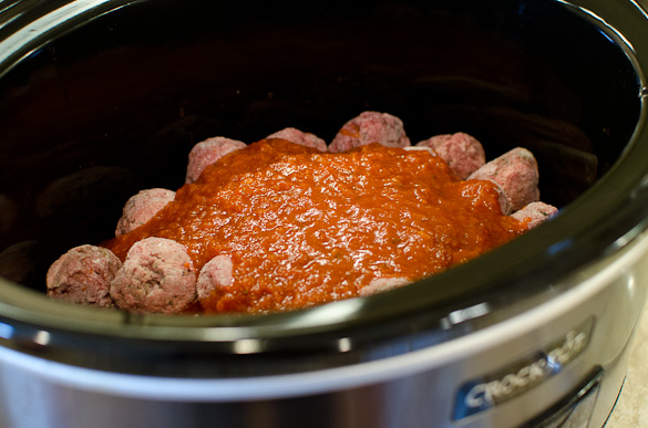 Frozen meatballs and marinara in a slow cooker.