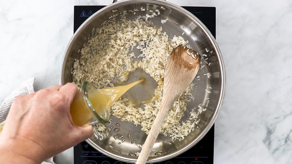 Pouring broth into rice pot