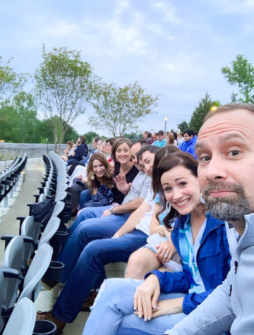Friends sitting in a row of seats at the Brandon Amphitheater