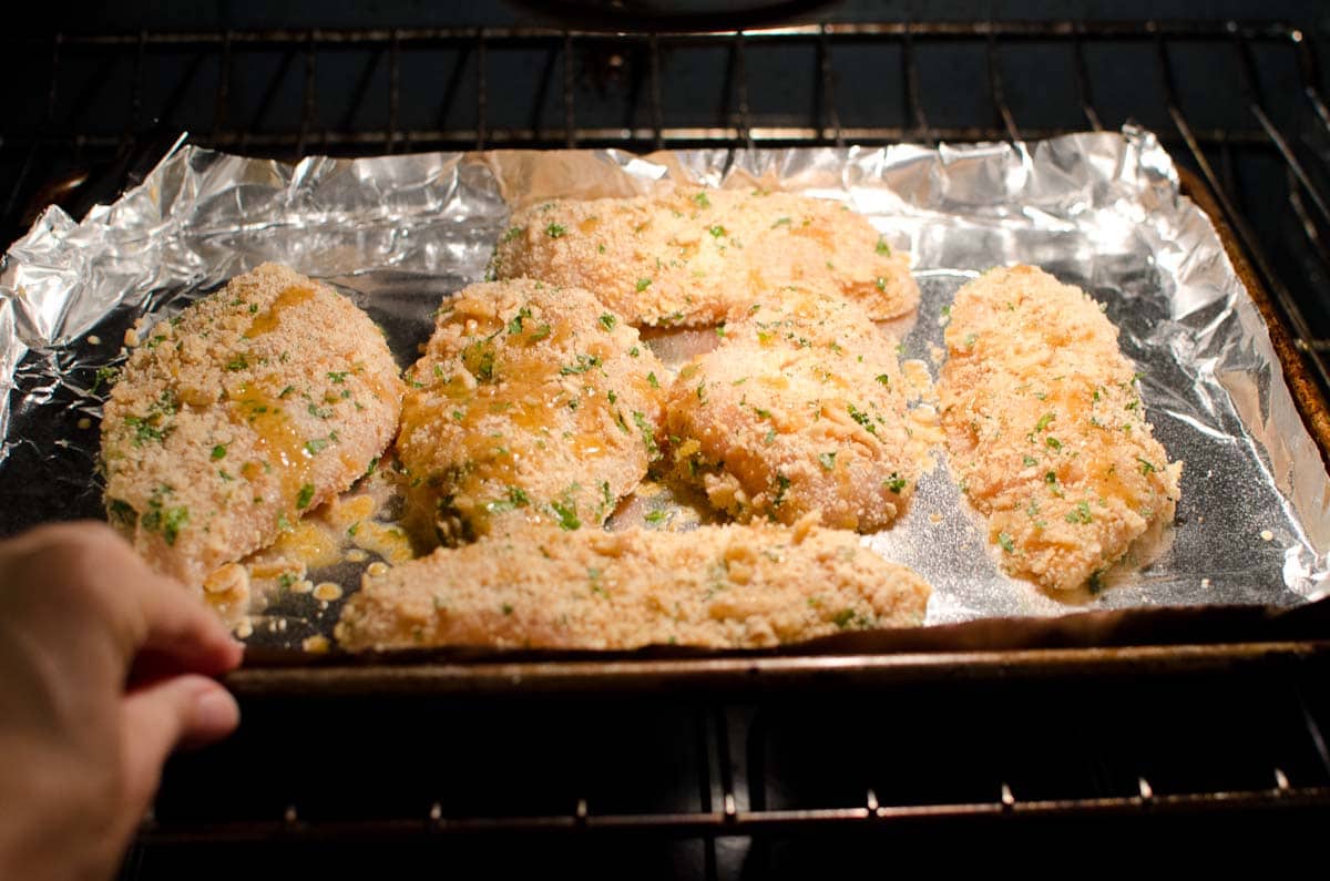 chicken breasts on foil lined baking sheet in oven