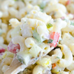 A wooden spoonful full of classic macaroni salad.