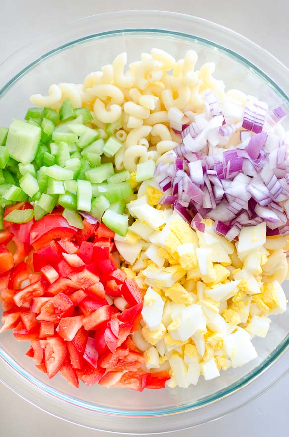 Bowl of ingredients for classic macaroni salad.