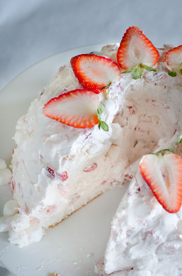 Layered angel food cake with strawberry marshmallow frosting.