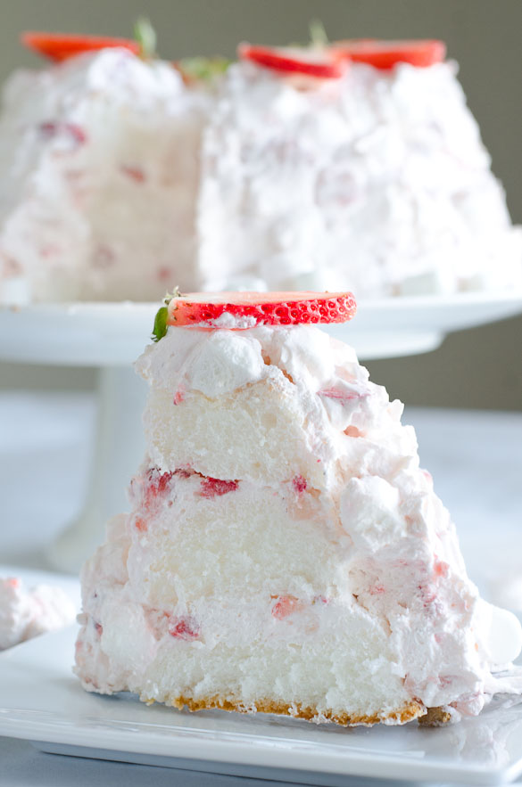 Slice of angel food cake with strawberry marshmallow frosting.