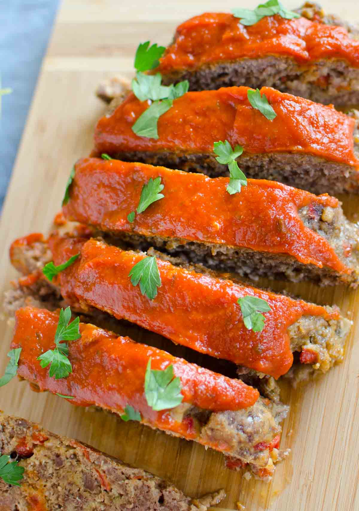 sliced italian meatloaf on cutting board