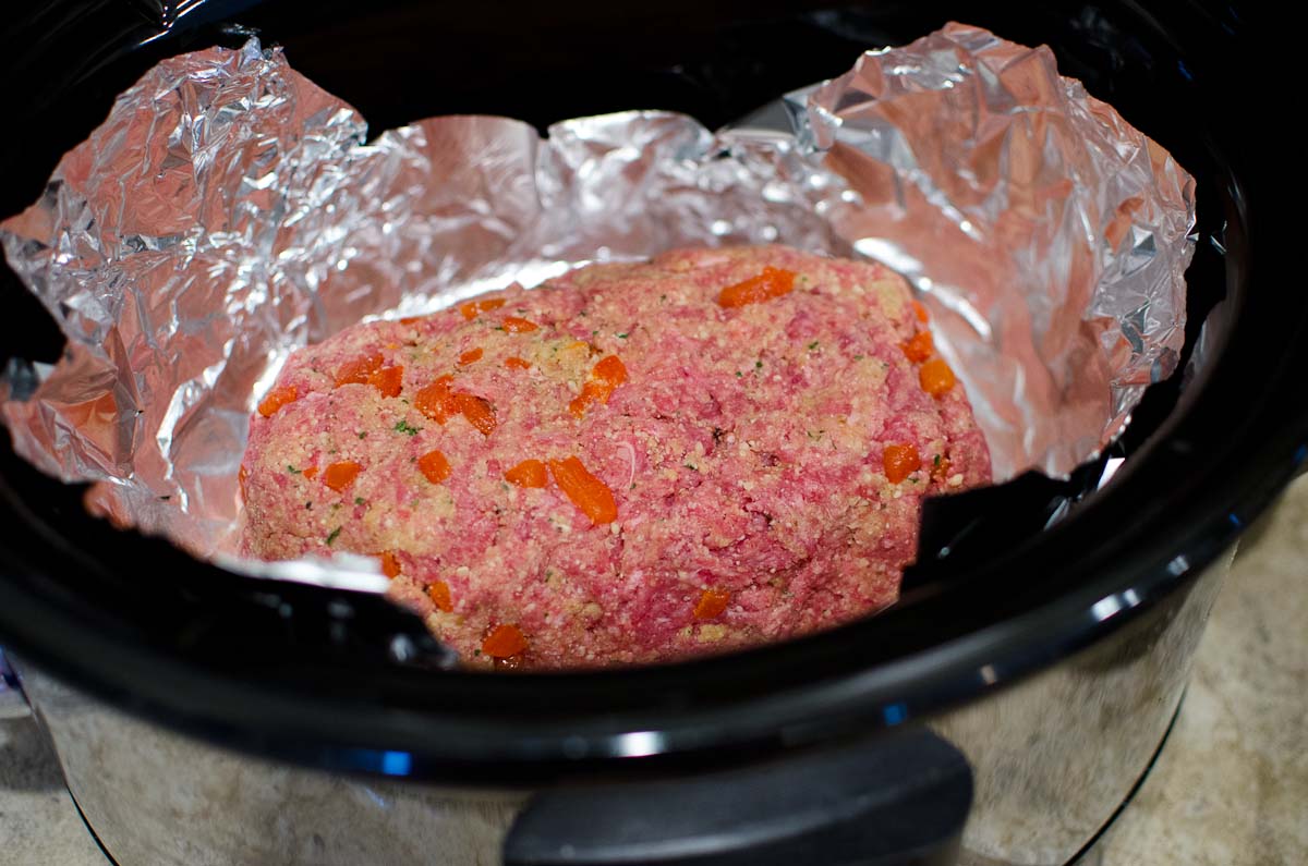 raw meatloaf in crock pot lined with foil