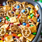 Snack mix with football shaped pretzels in a football shaped bowl.