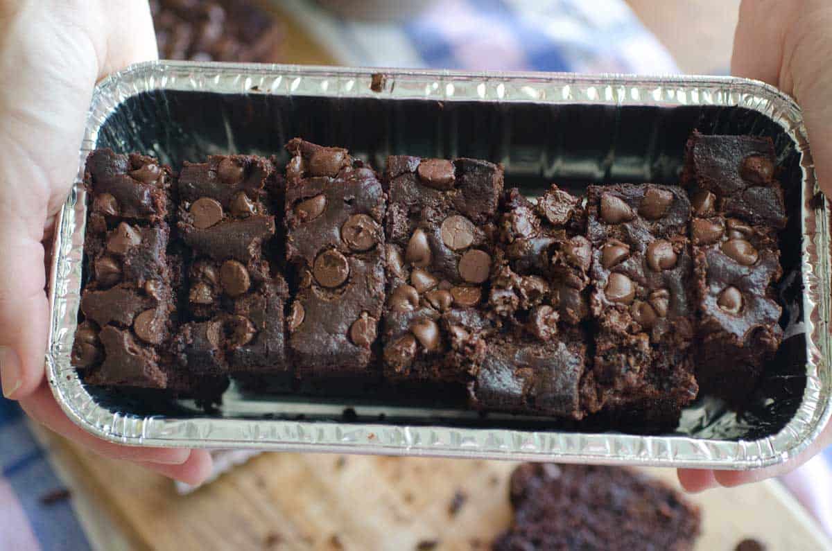 slices of chocolate banana bread in a foil loaf pan