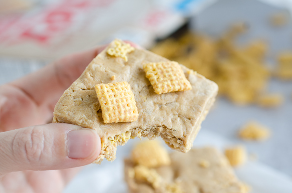 Bite of protein bar with chex cereal.