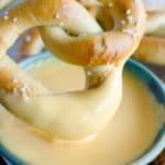 soft pretzel dipped in beer cheese