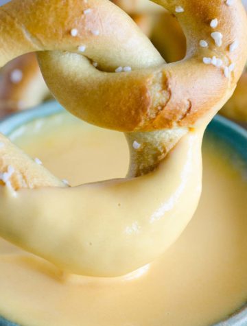 soft pretzel dipped in beer cheese