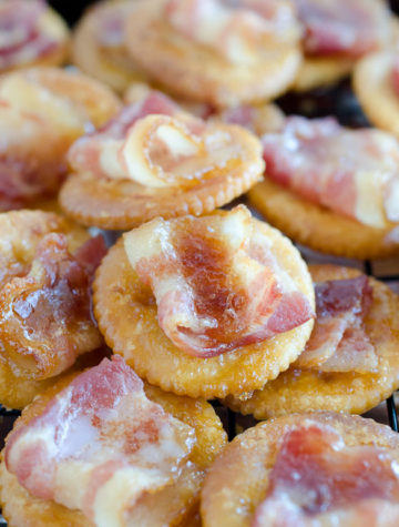 Pile of ritz crackers with candied bacon on top