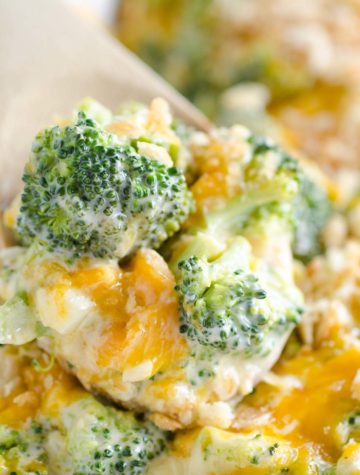 cheesy broccoli in a wooden spoon