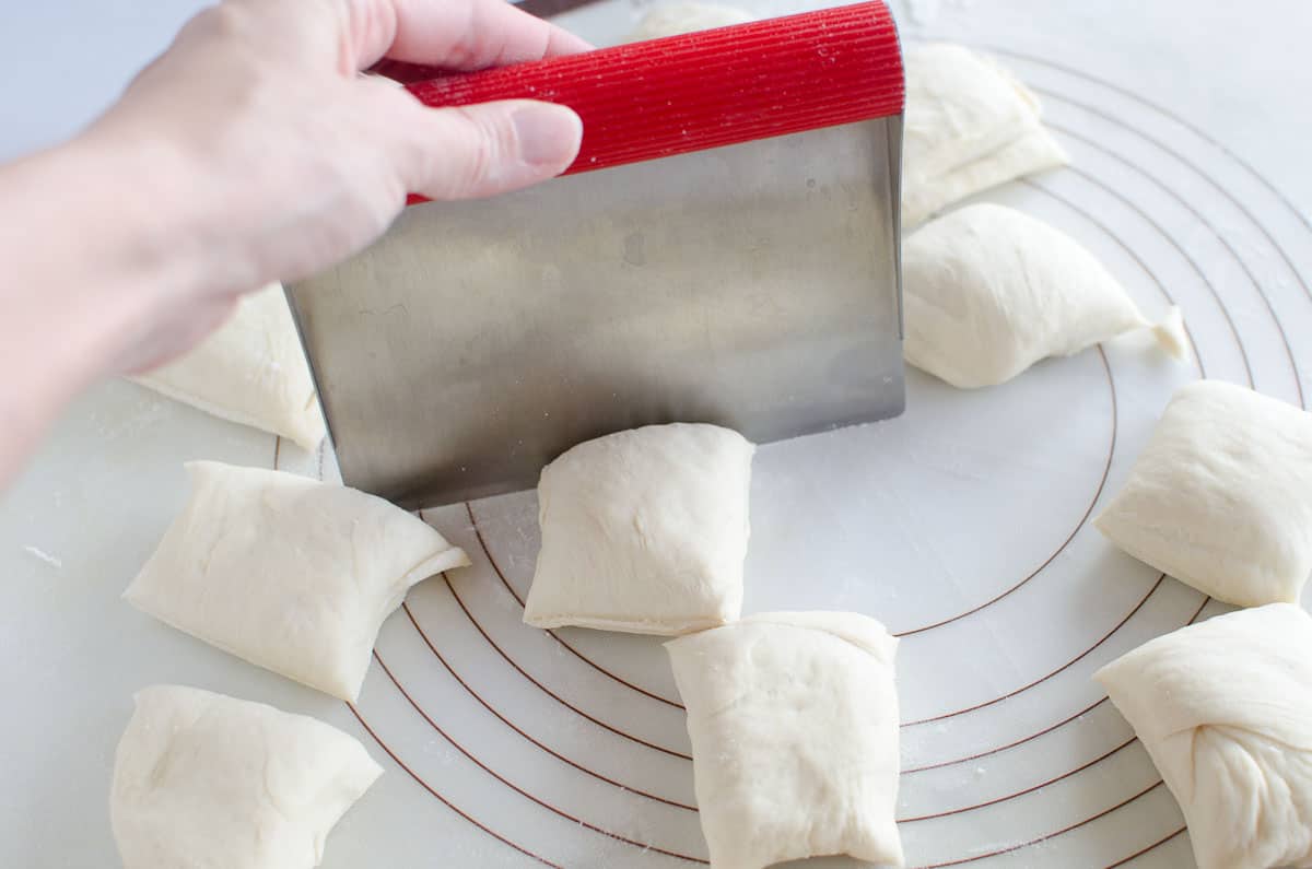 using dough cutter to cut dough into pieces