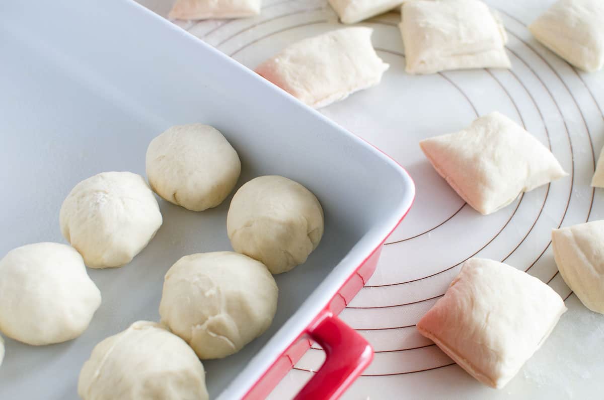 dough balls in pan and pastry mat