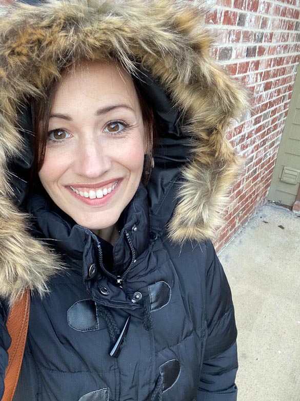 female in faux fur hooded winter coat