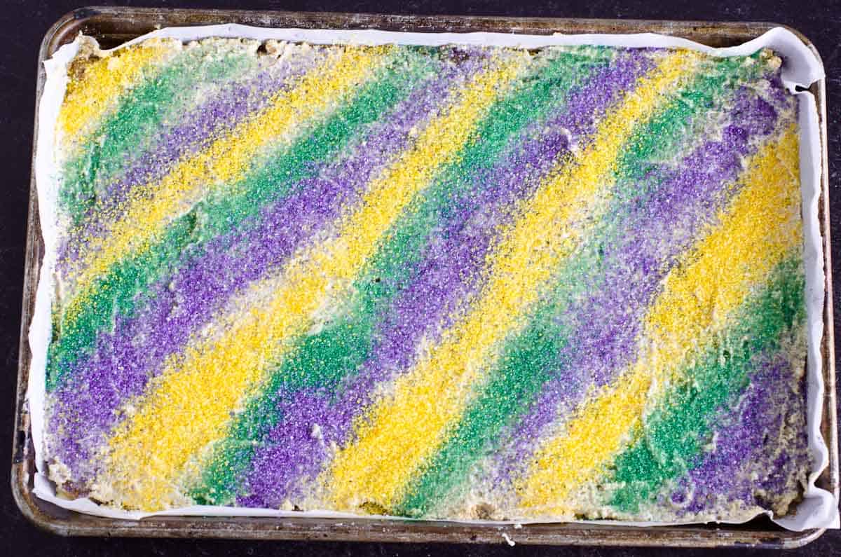 yellow green and purple sprinkles in stripe pattern on baking sheet