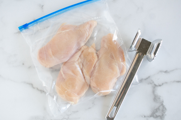 chicken breasts in freezer bag with meat mallet