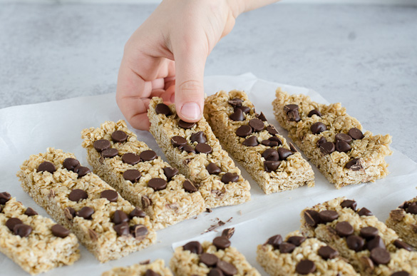 kid hand grabbing homemade granola bar