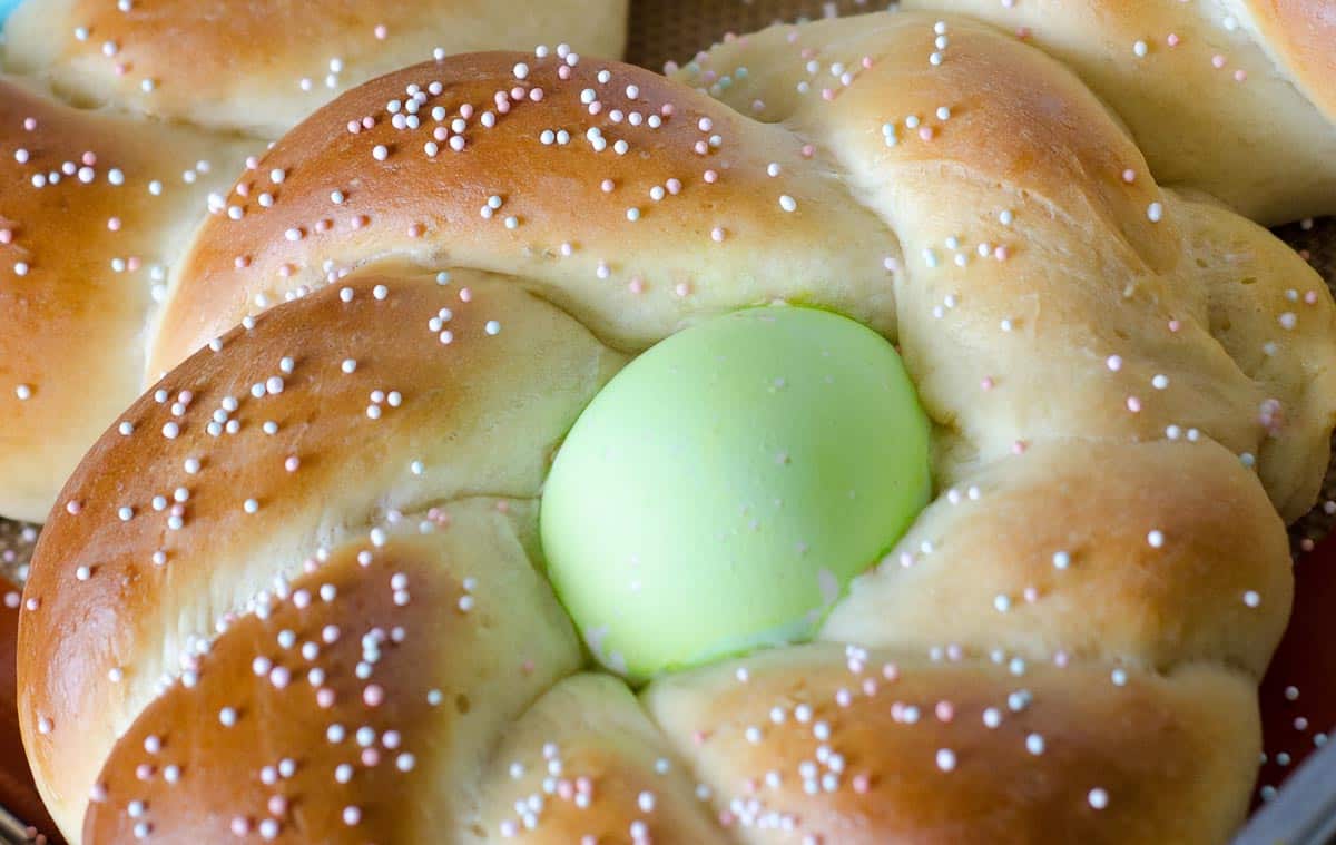 close up of braided Easter bread with green egg in center