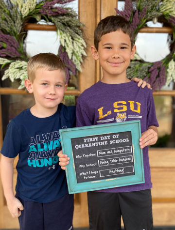 two kids with first day quarantine school sign