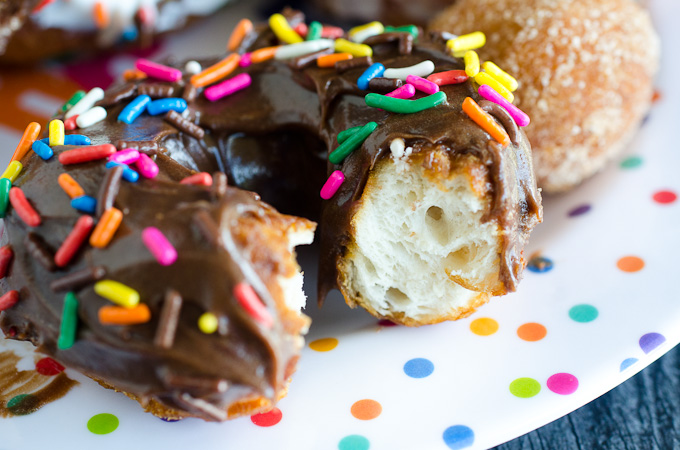 bite out of chocolate donut with sprinkles