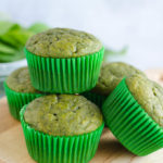 green spinach muffins stacked on cutting board