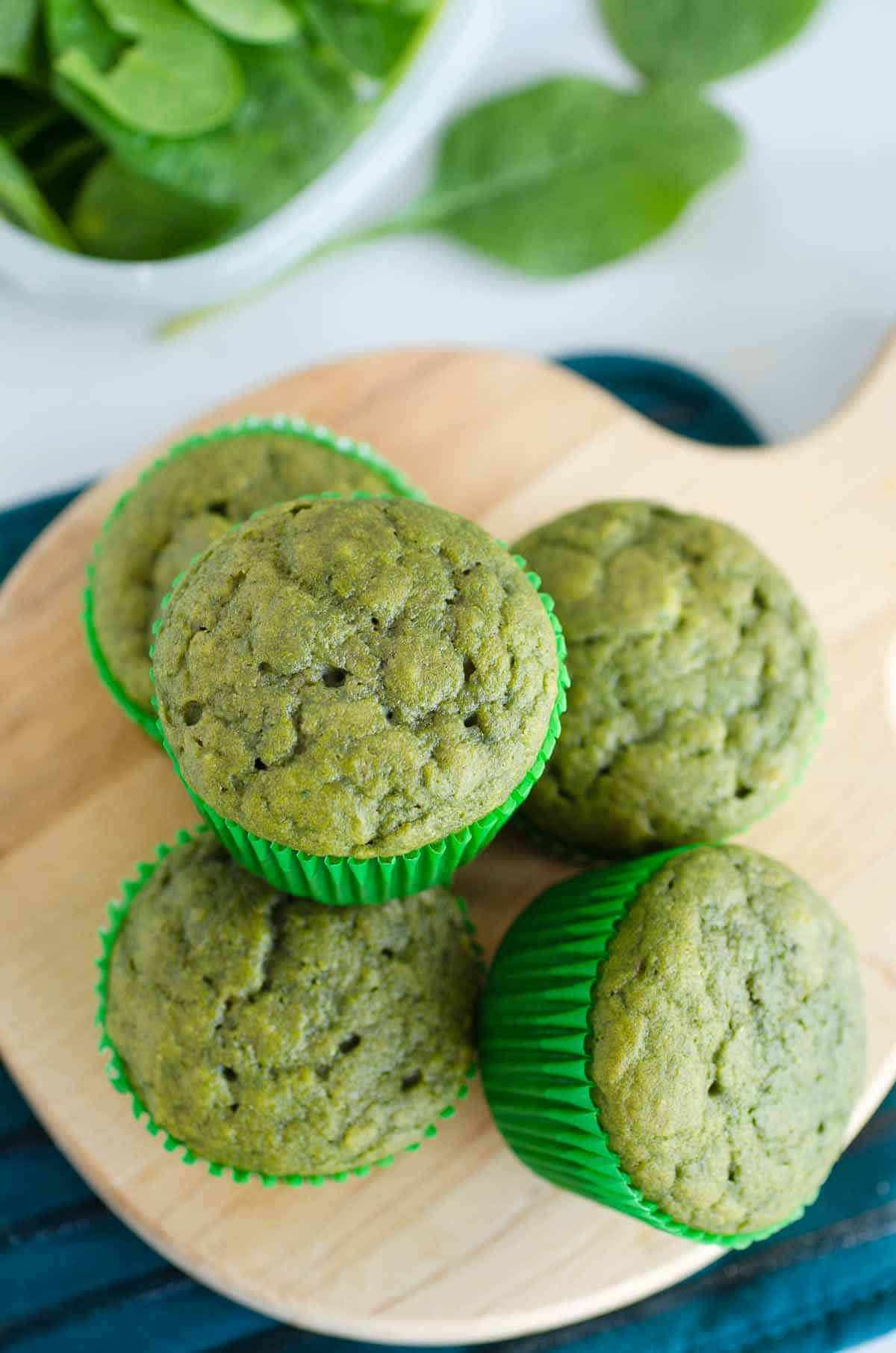 green muffins on a wooden board