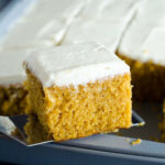 pumpkin bars with cream cheese frosting scooped out of pan