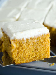 pumpkin bars with cream cheese frosting scooped out of pan