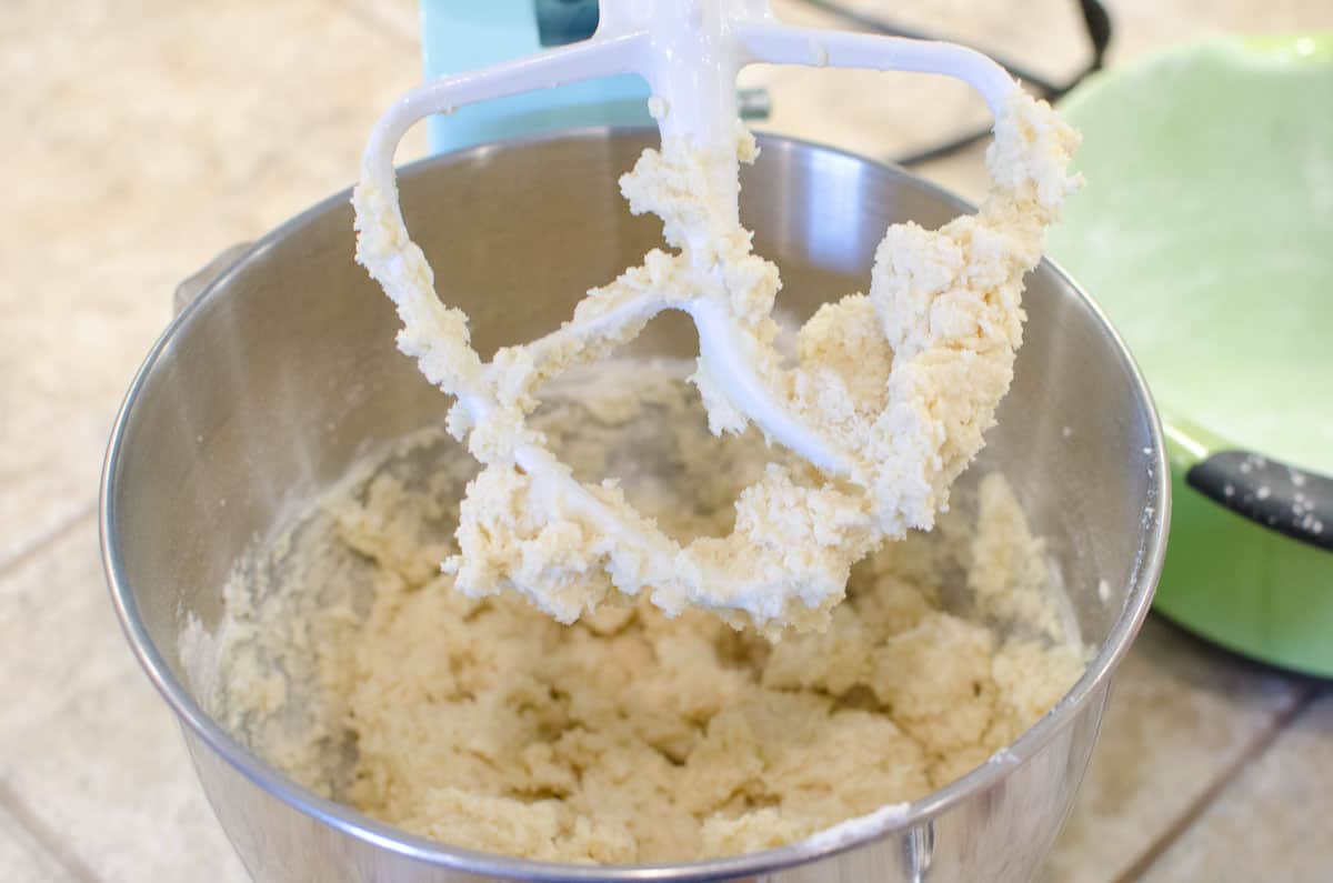 mixing sugar cookie dough in stand mixer with paddle attachment