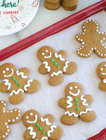 gingerbread cookies on a red baking sheet