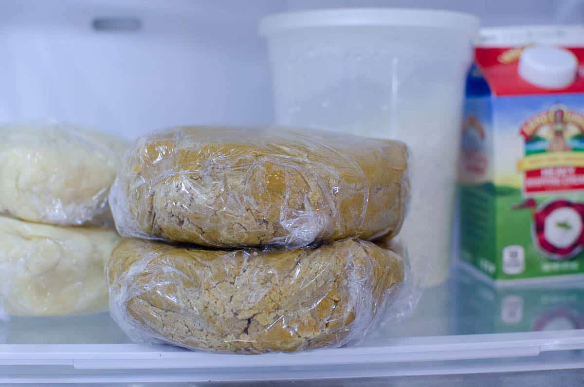 gingerbread cookie dough chilling in fridge wrapped in plastic wrap