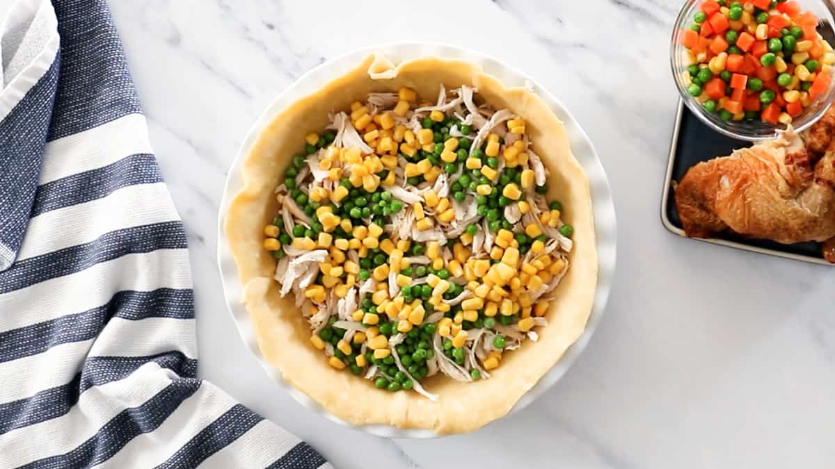 pie shell with shredded chicken and frozen vegetables for pot pie