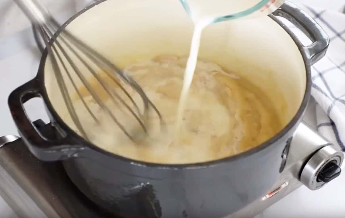 whisking milk into hot saucepan