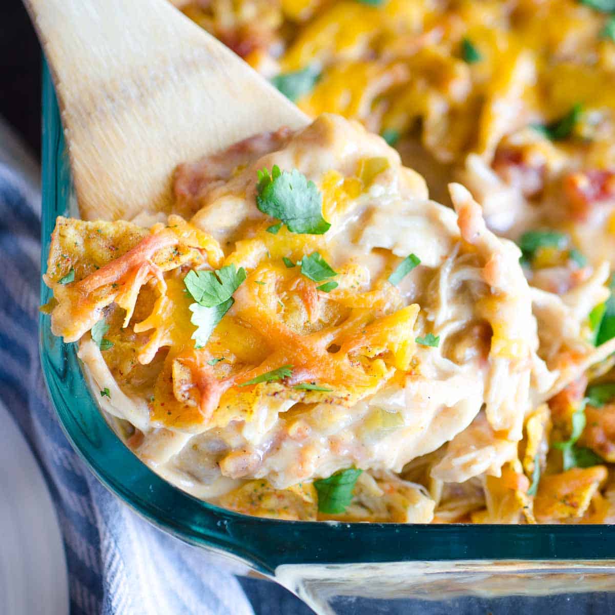 leftover chicken dorito casserole scooped with a wooden spoon