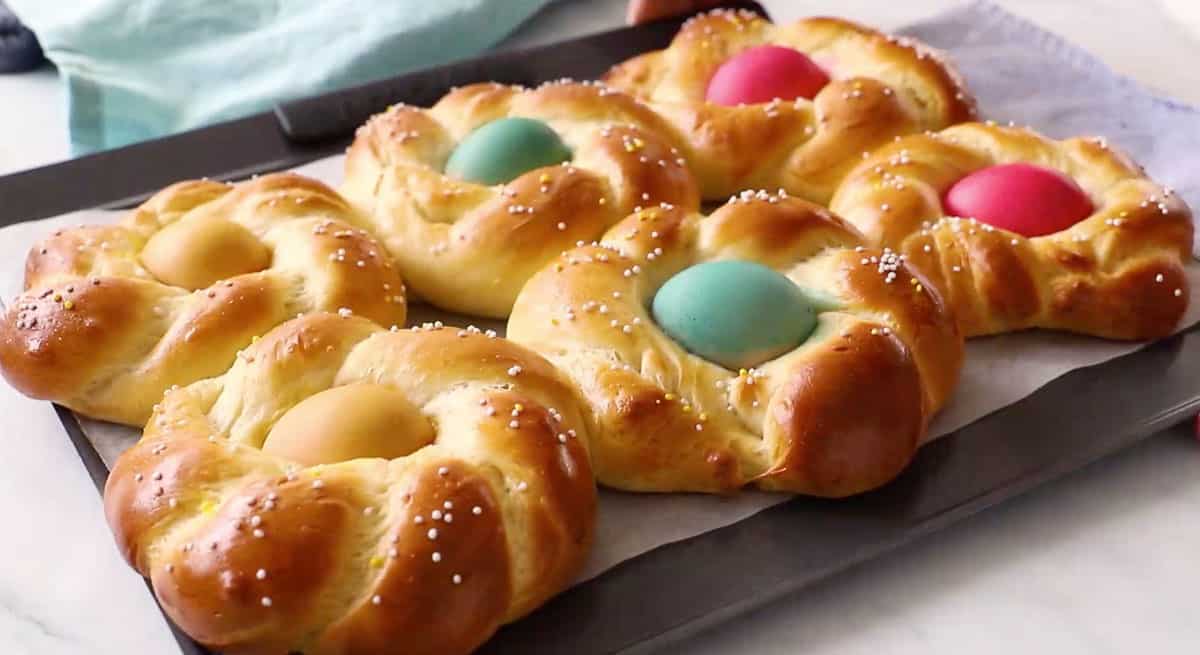 baking sheet with braided bread wreaths with dyed eggs in center