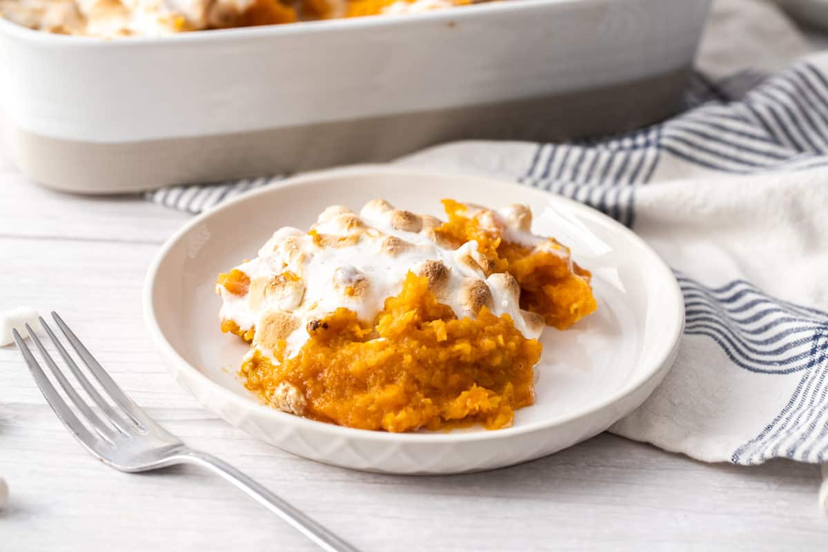 serving of sweet potato casserole with marshmallows on plate with fork
