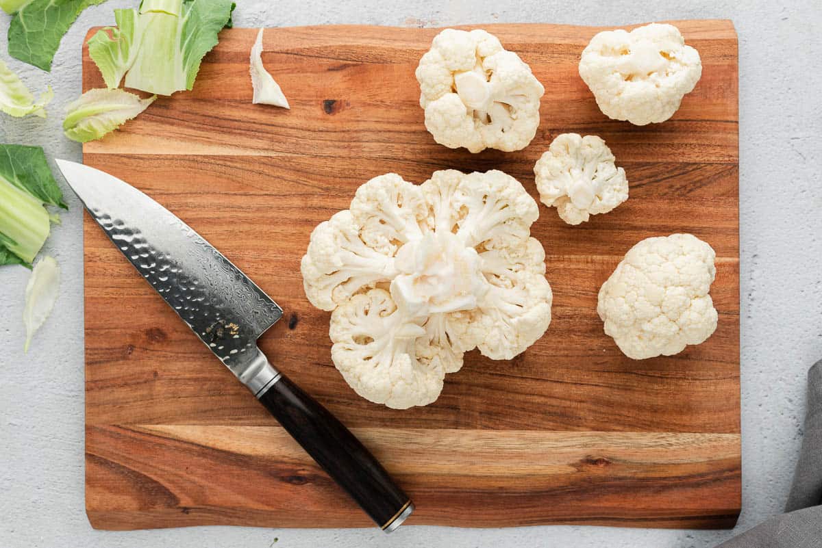 cauliflower and knife on cutting board