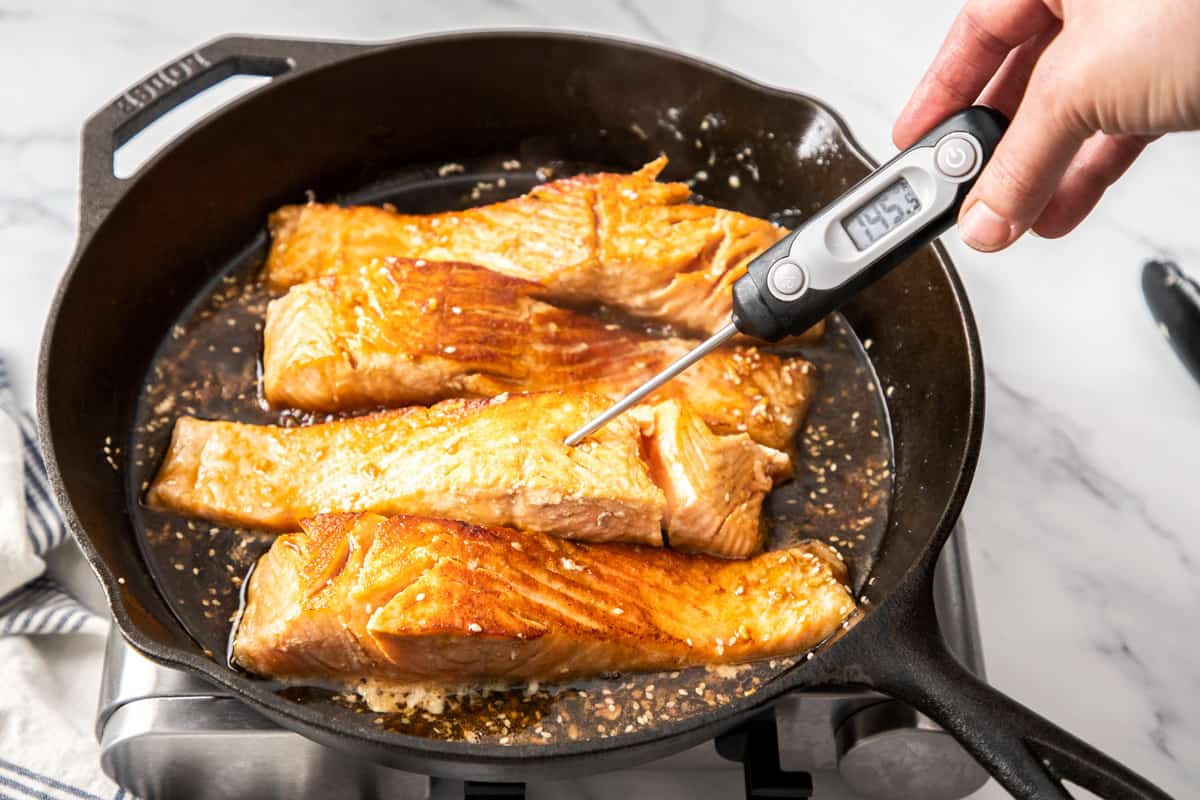 instant read thermometer in skillet salmon