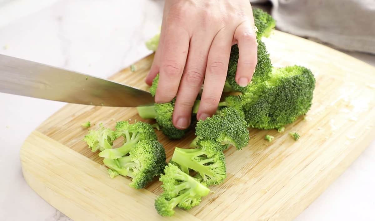cut broccoli florets on wooden cutting board