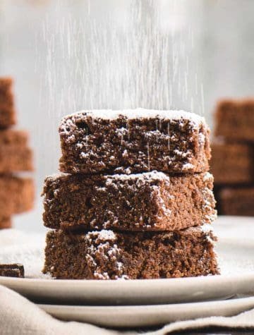 sugar sprinkled over stack of brownies