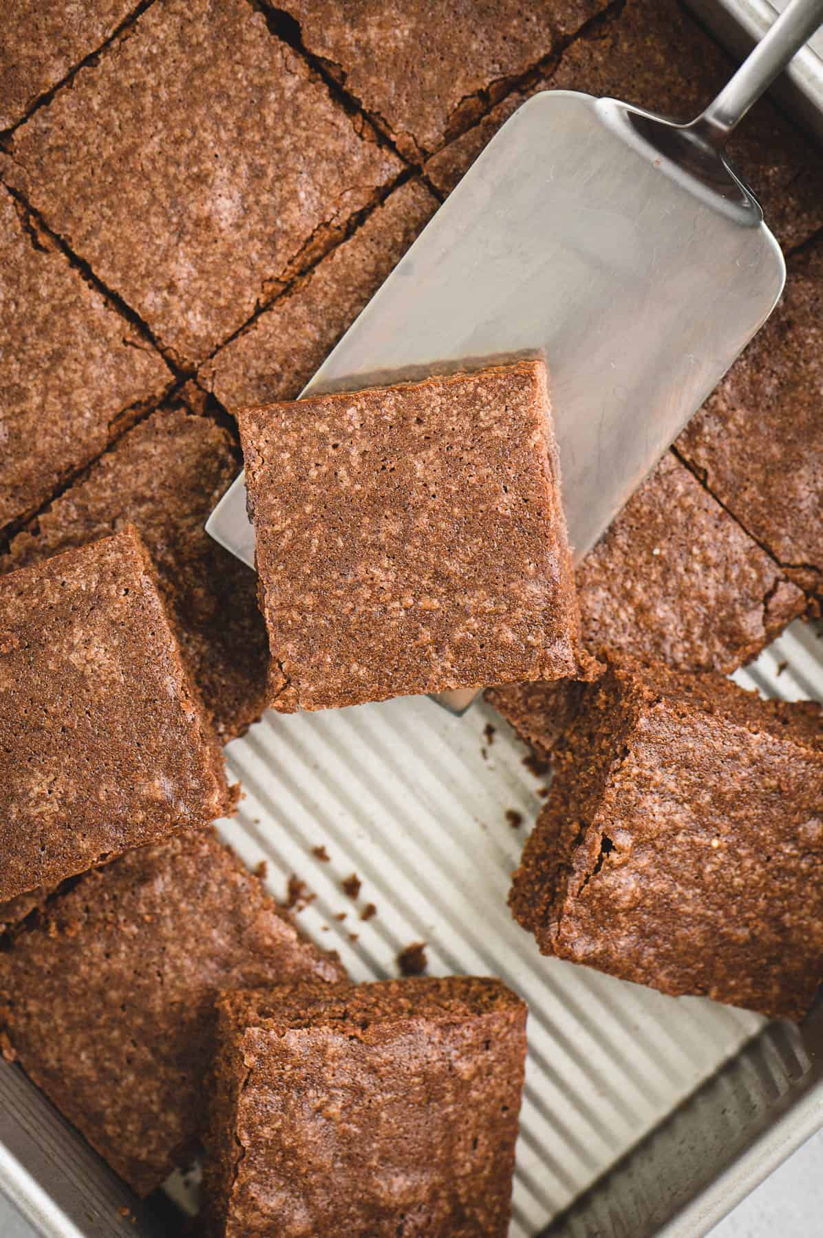 brownies sliced in squares with a metal spatula