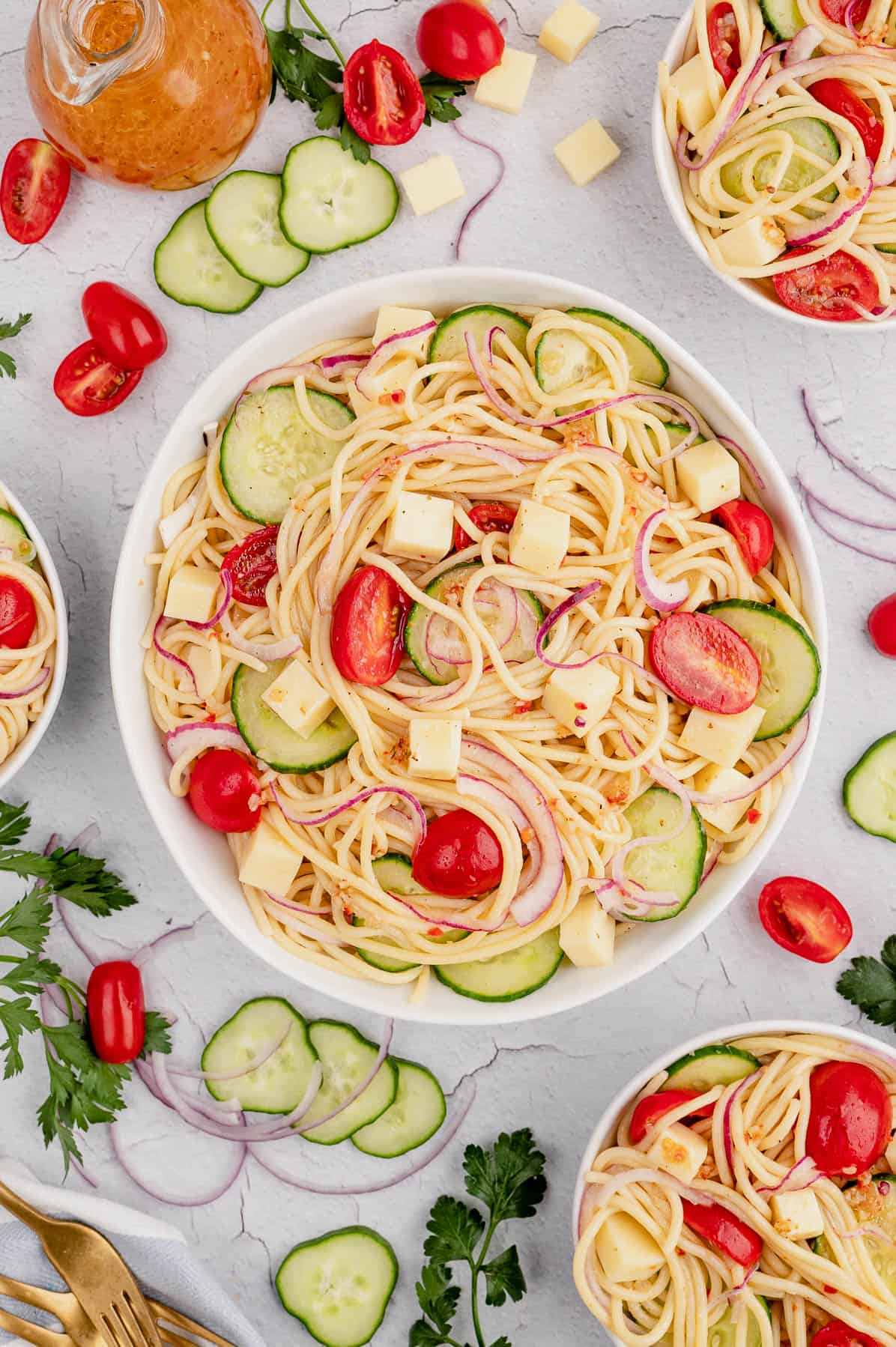 bowl of spaghetti salad with cucumbers and tomatoes